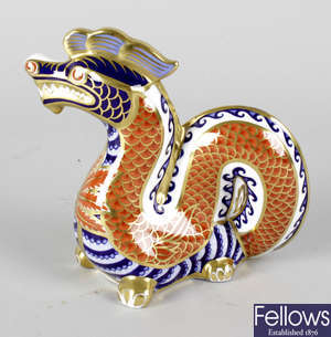 A Royal Crown Derby porcelain paperweight modelled as a dragon.