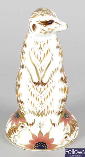 A Royal Crown Derby porcelain paperweight modelled as a meerkat.
