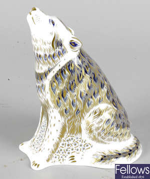 A Royal Crown Derby porcelain paperweight modelled as a wolf.