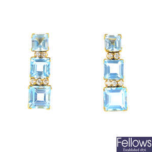 A pair of topaz and diamond earrings.