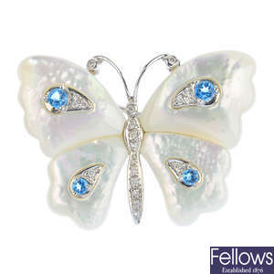 A mother-of-pearl, diamond and topaz butterfly brooch.