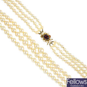 A cultured pearl three-row necklace, with garnet and cultured pearl clasp.