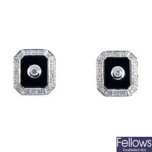 A pair of onyx and diamond stud earrings.
