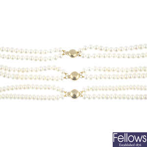 Three cultured pearl two-row necklaces.