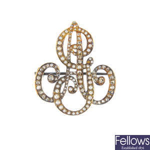 An Edwardian 18ct gold diamond and split pearl monogram brooch.