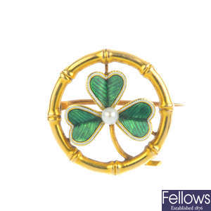 An early 20th century gold enamel and seed pearl shamrock brooch.