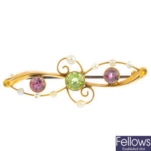 An early 20th century 15ct gold tourmaline, peridot and seed pearl brooch.