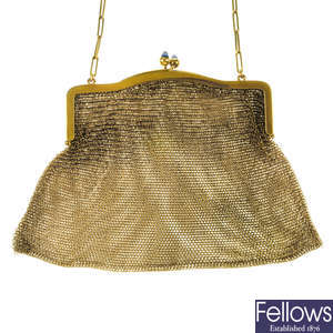 Three early 20th century purses, to include a silver German purse and a 9ct mounted lizard skin purse.
