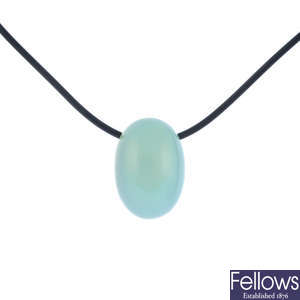 A chalcedony pendant, on cord.