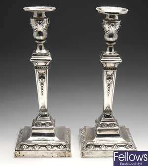 An Edwardian pair of silver mounted candlesticks.