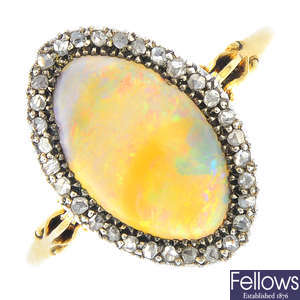 An early 20th century silver and 18ct gold, opal and diamond cluster ring.