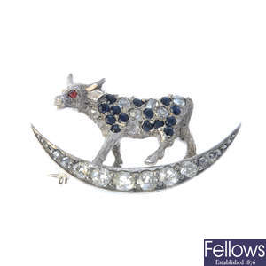 A diamond, sapphire and gem-set cow and moon nursery rhyme brooch.