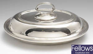 A modern silver entrée dish and cover.