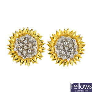A pair of diamond floral earrings.