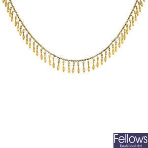 A mid Victorian Etruscan revival 18ct gold fringe necklace.