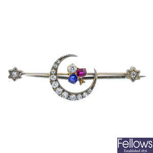 A late Victorian silver and gold, diamond, sapphire and ruby crescent moon brooch.