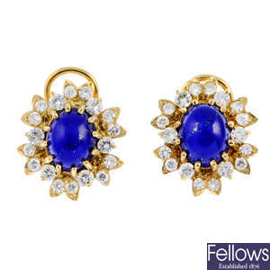 A pair of lapis lazuli and diamond cluster earrings.