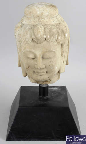 An Eastern carved sandstone head.