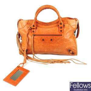 BALENCIAGA - an orange Classic City handbag.