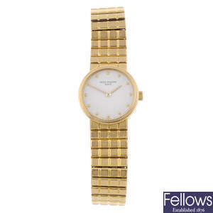 PATEK PHILIPPE - a lady's 18ct yellow gold Calatrava bracelet watch.