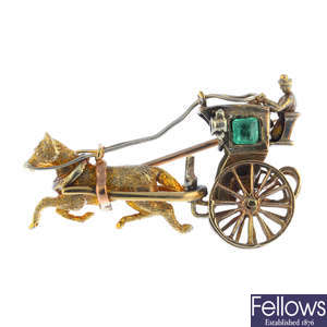 A 1970s 9ct gold emerald horse and carriage brooch.