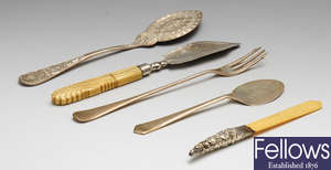 A selection of flatware and cutlery to include a mid-Victorian silver butter spade, etc.