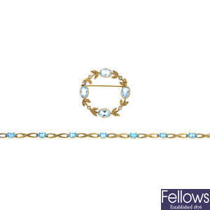 A 14ct gold topaz and diamond bracelet and a 9ct gold aquamarine and split pearl brooch.