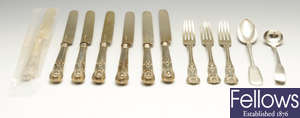 A selection of flatware and cutlery to include a George III silver mustard spoon, a part set of late Victorian silver-gilt fruit knives and forks, etc.