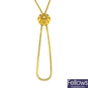 A late Victorian 18ct gold long guard chain, with locket slider, circa 1870.