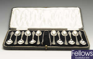 A 1920's set of twelve silver teaspoons and a pair of sugar tongs, etc.