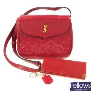 YVES SAINT LAURENT - a red crossbody handbag with wallet.
