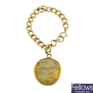 A bracelet, suspending a Spanish coin pendant.