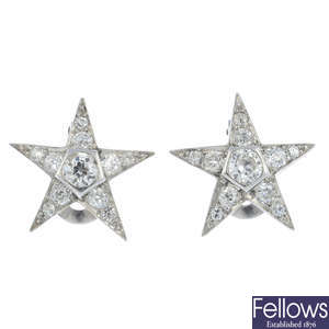 A pair of diamond star earrings.