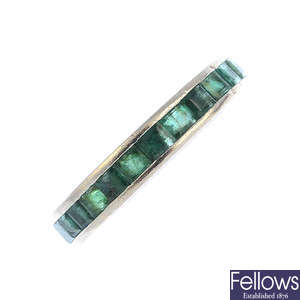 An 18ct gold emerald full eternity ring.