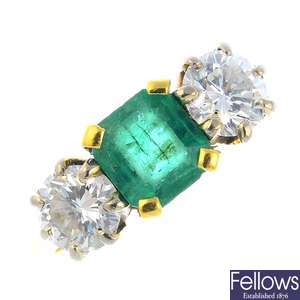 An 18ct gold platinum emerald and diamond three-stone ring.