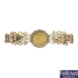 A 9ct gold mounted half sovereign gate bracelet.