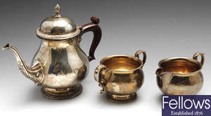 A modern three piece silver tea service.