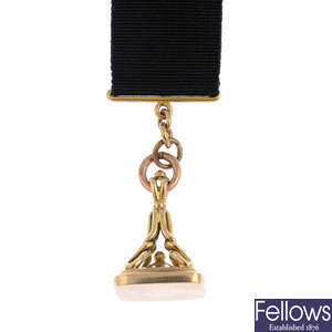 An early 20th century 9ct gold fob, with 9ct gold moire Albertina.