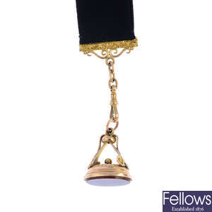 An early 20th century 9ct gold carnelian fob on a 9ct gold moire Albertina.