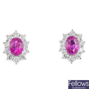 A pair of ruby and diamond cluster earrings.