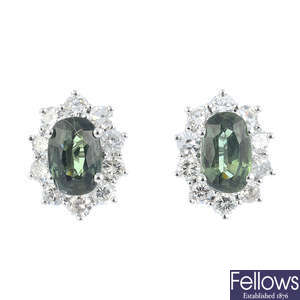 A pair of green sapphire and diamond cluster earrings.