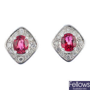 A pair of red sapphire and diamond earrings.