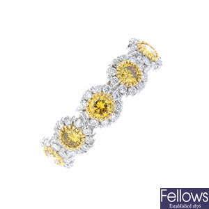 An 18ct gold 'yellow' diamond and diamond ring.