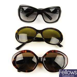 Three pairs of designer sunglasses. 