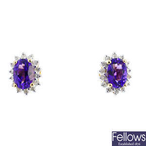 A pair of diamond and amethyst cluster earrings.