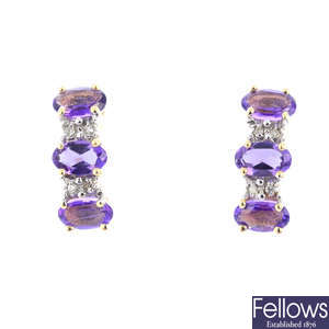 A pair of amethyst and diamond earrings.