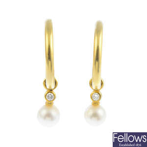 A pair of cultured pearl and diamond hoop earrings.