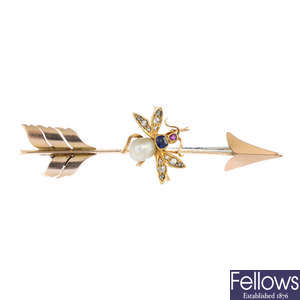 An early 20th century 15ct gold pearl, sapphire, ruby and diamond fly and arrow brooch.