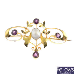 An early 20th century 9ct gold garnet and mother-of-pearl brooch.