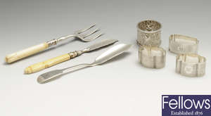 A miscellaneous lot to include a William IV butter knife, a Victorian butter knife & toasting fork, napkin rings., etc.